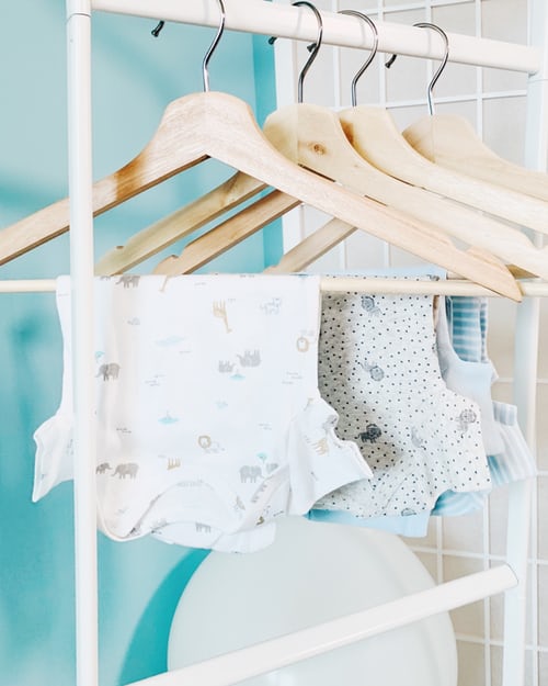 Baby clothes hanging up